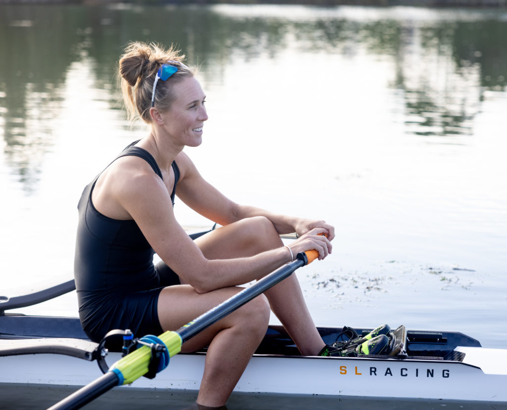 Emma Twigg sits on an SL Racing row boat on the banks of the Clive River